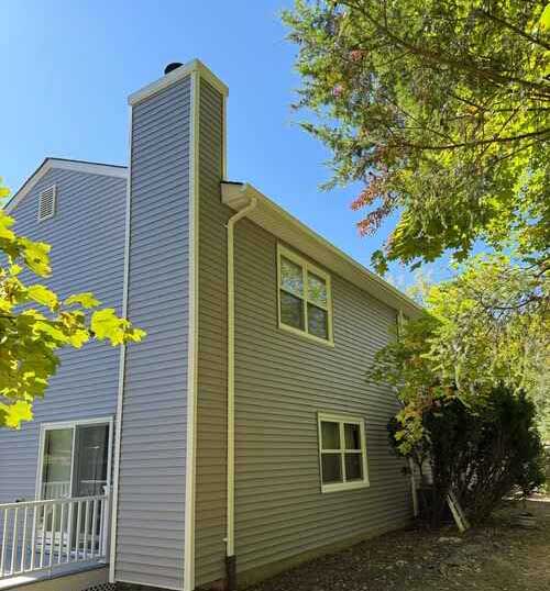 Residential home with new vinyl siding and roof renovation in Monmouth County, New Jersey.