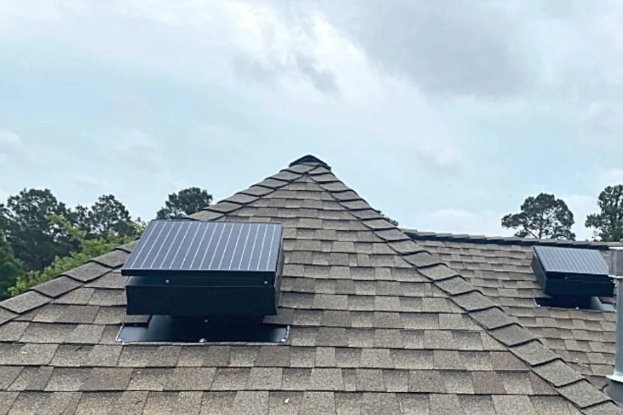 Worker adding insulation in a residential attic.