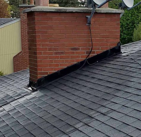 Technician sealing a leaking chimney area.
