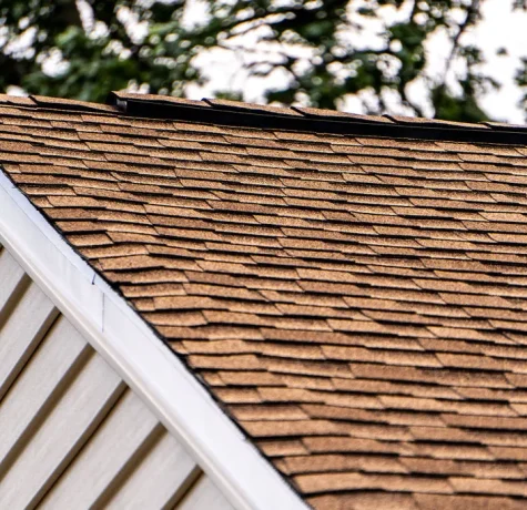 Technician inspecting a commercial flat roof.