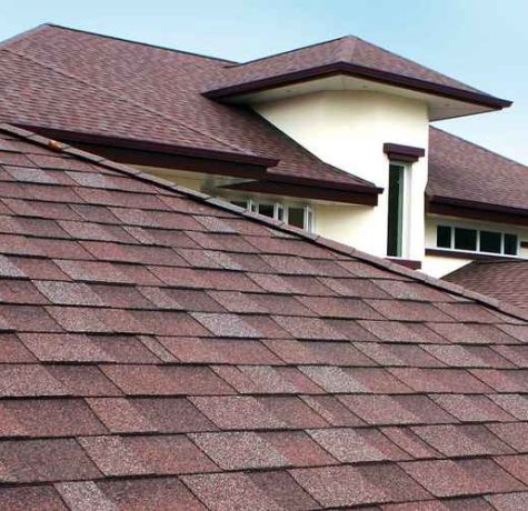 Roofing crew installing new shingles.