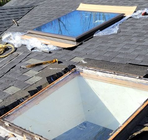 Technician repairing a leaking skylight.