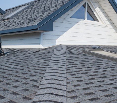 Aging asphalt roof showing wear, missing granules, and signs that replacement is needed.