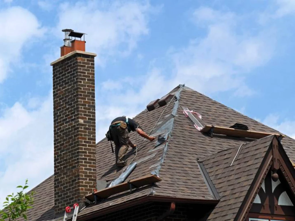 Roof repair contractor working on residential roof in New Jersey