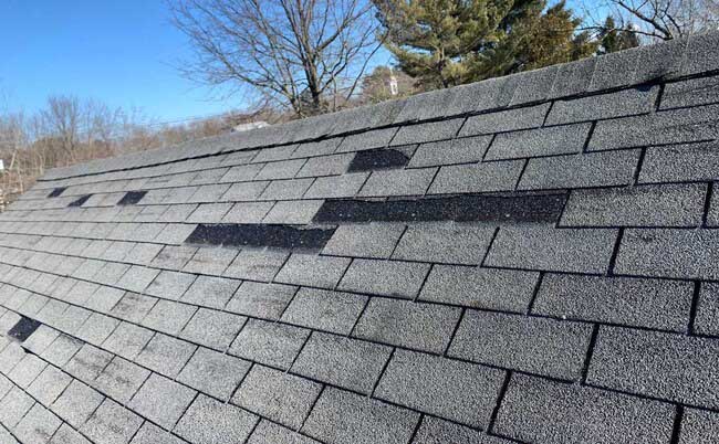 Roof gutter system with shingle edge protection in New Jersey home