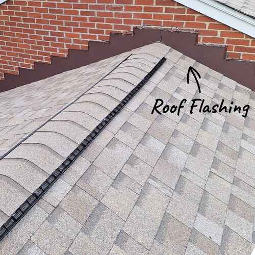 Roof flashing installation on asphalt shingles for residential home in New Jersey.