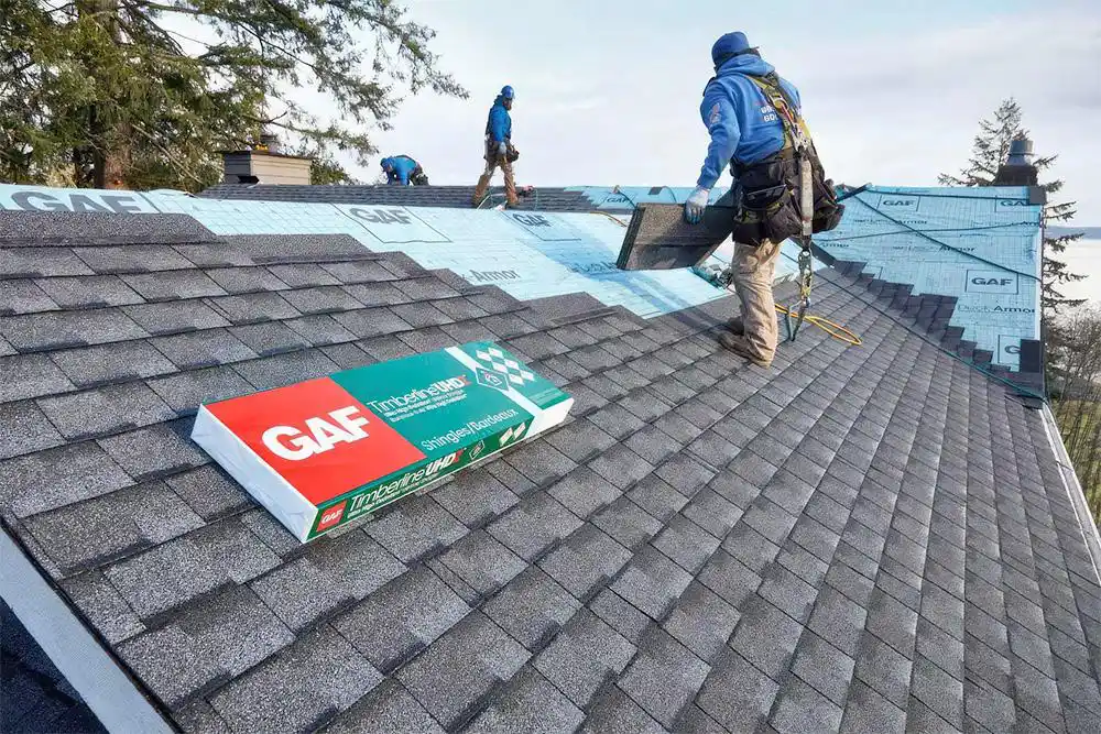 Roof repair professionals installing GAF asphalt shingles on a residential roof in New Jersey