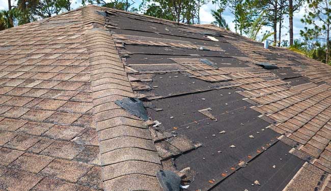 Roof damage after a severe storm in New Jersey – missing shingles and exposed underlayment.